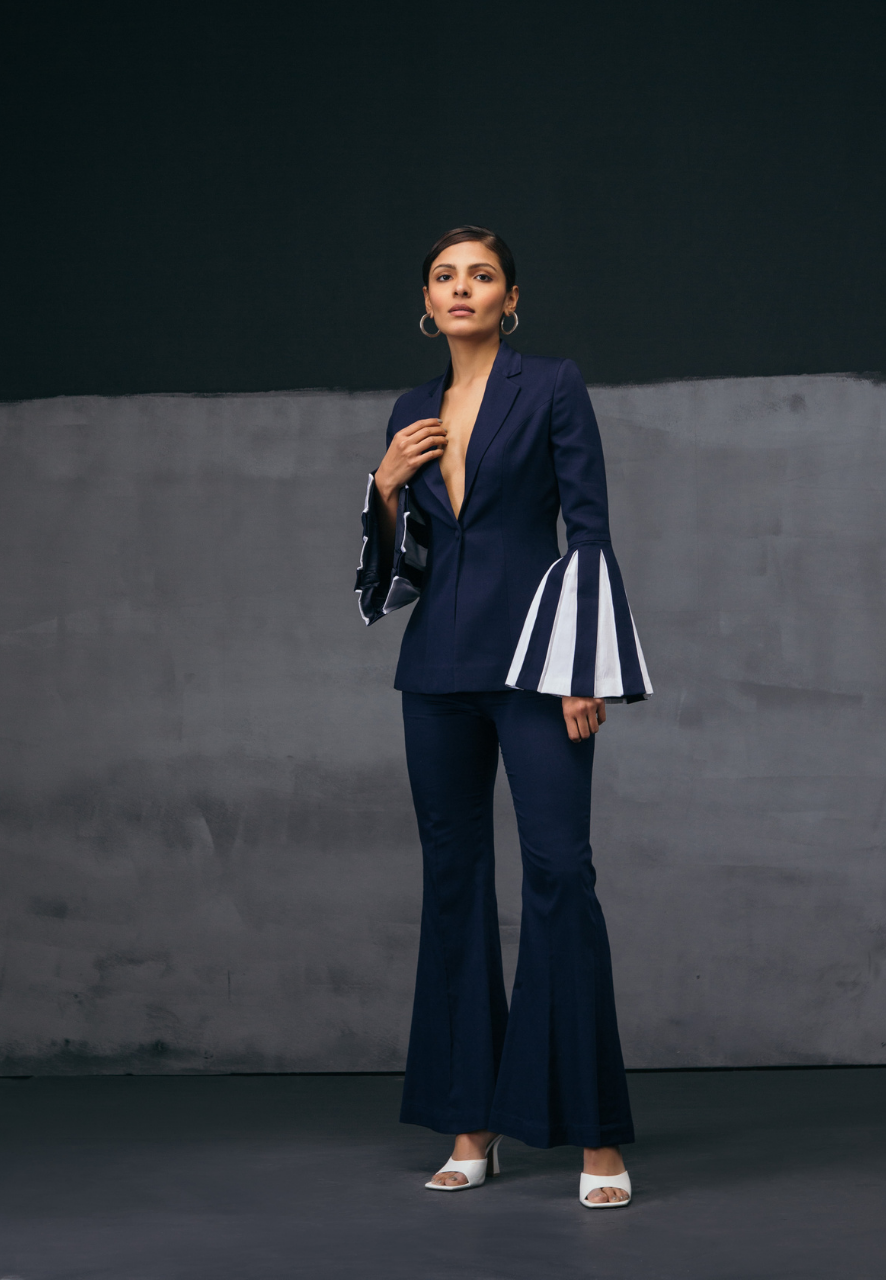 Layer up this season in our best quality jacket and pant sets. Crafted from airy cotton which is light to wear and perfect for all seasons and layering. The best part of the jacket is long contrasting bell sleeves in white and navy blue which adds glamour and depth to your look with flared blue pants. These pants sit high on the waist for comfort. This look is perfect for your next big meeting, formal event or even a dinner. Pair the co-ord set with heeled sandals and minimal diamond jewelry.