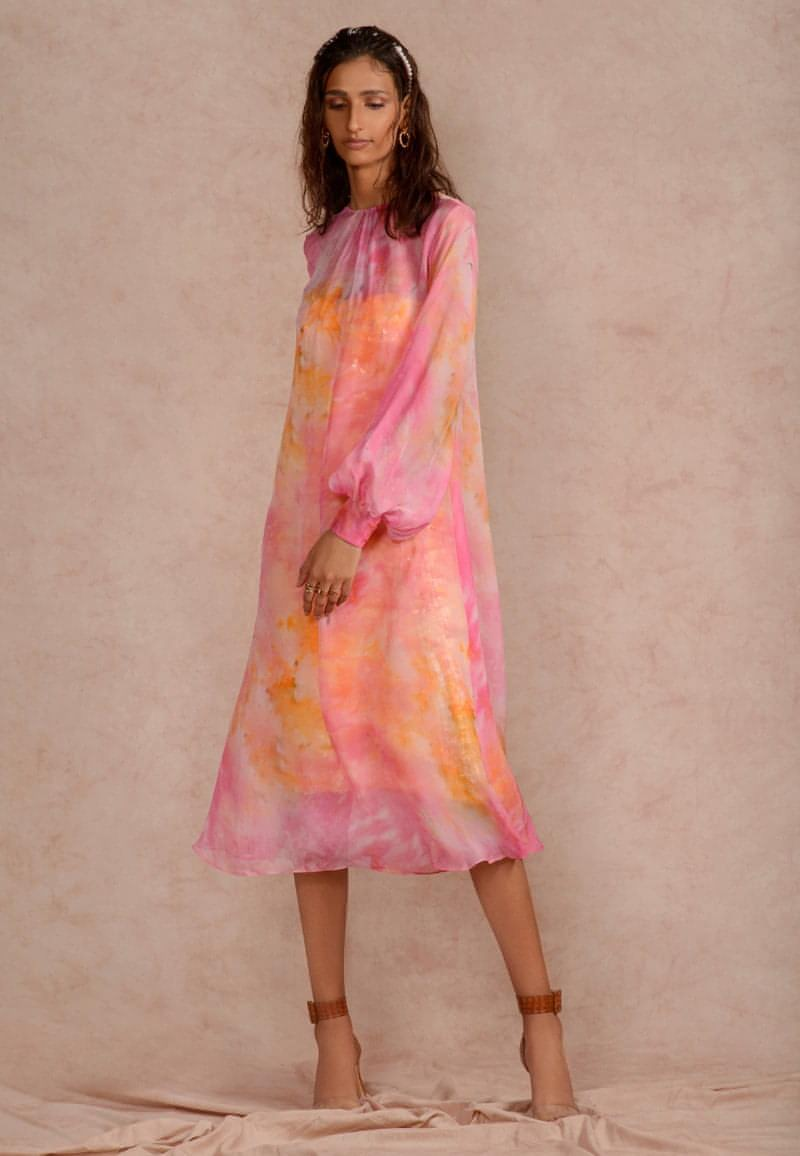 This pink and yellow sheer dye print midi dress with a sequin dress underneath can be styled in multiple ways. Made in chiffon and crepe this ensemble with handcrafted bandeau is perfect for the next date or formal evenings. Wear the piece in summer or style it in winter with an overlap jacket and stylish boots