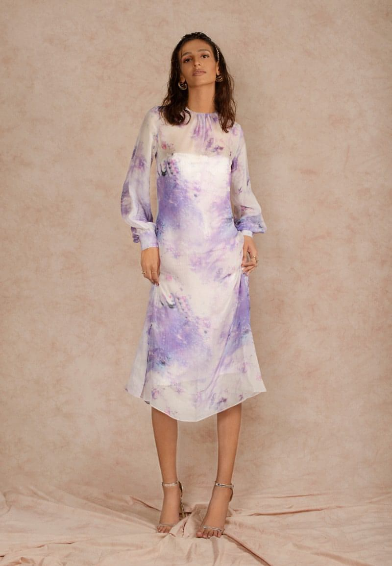 This purple and white sheer dye print midi dress with a sequin dress underneath can be styled in multiple ways. Made in chiffon and crepe this ensemble with handcrafted bandeau is perfect for the next date or formal evenings. Wear the piece in summer or style it in winter with an overlap jacket and stylish boots