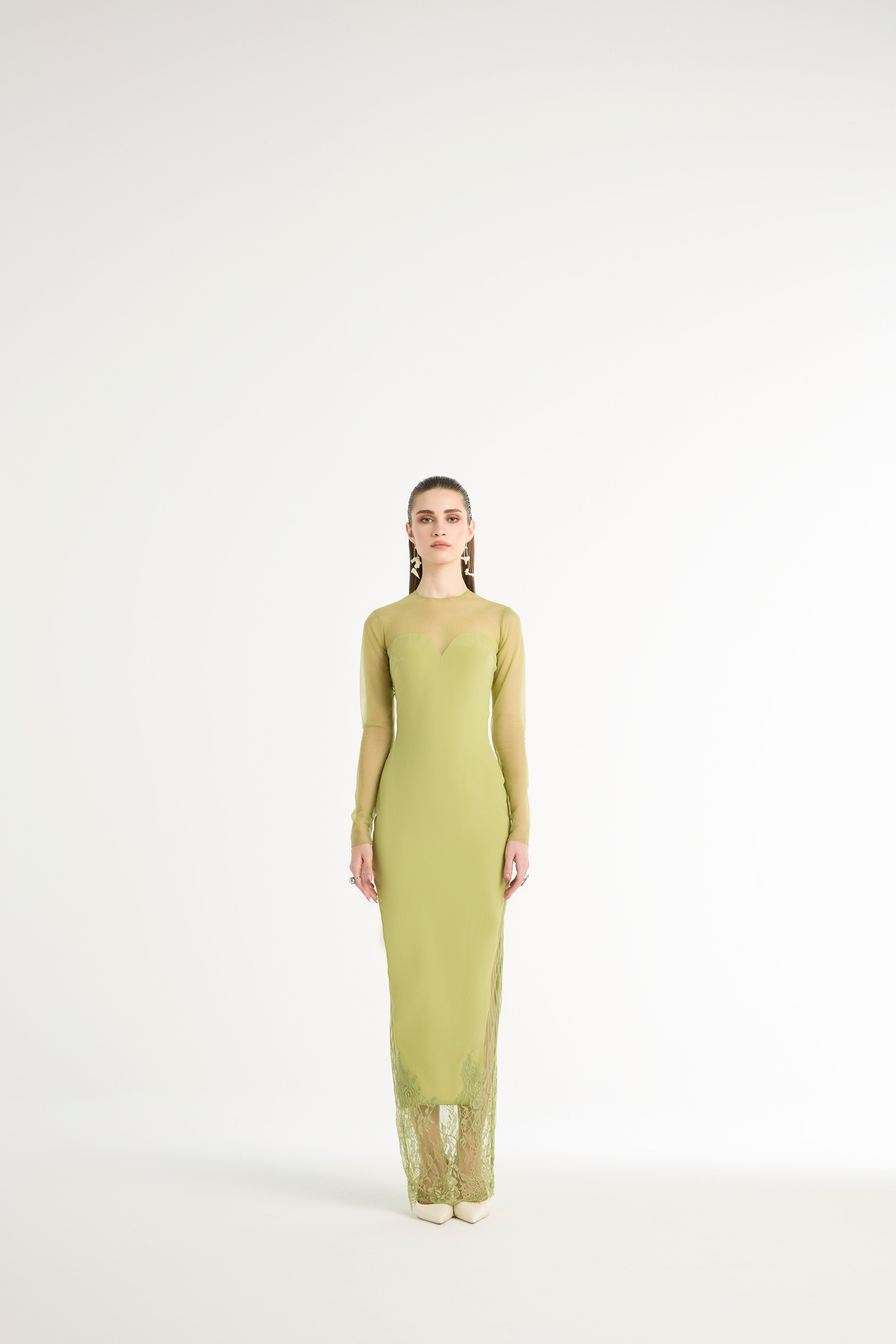 Woman wearing a green dress on a white background